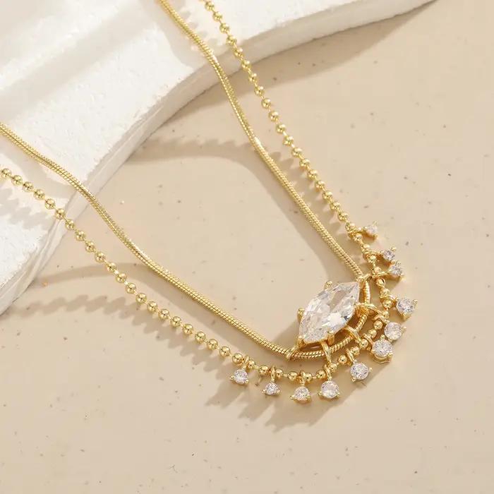 Collier de luxe en cuivre pour femmes avec pierres précieuses artificielles de forme marquise et design à pompon, idéal pour les mariages et les banquets.