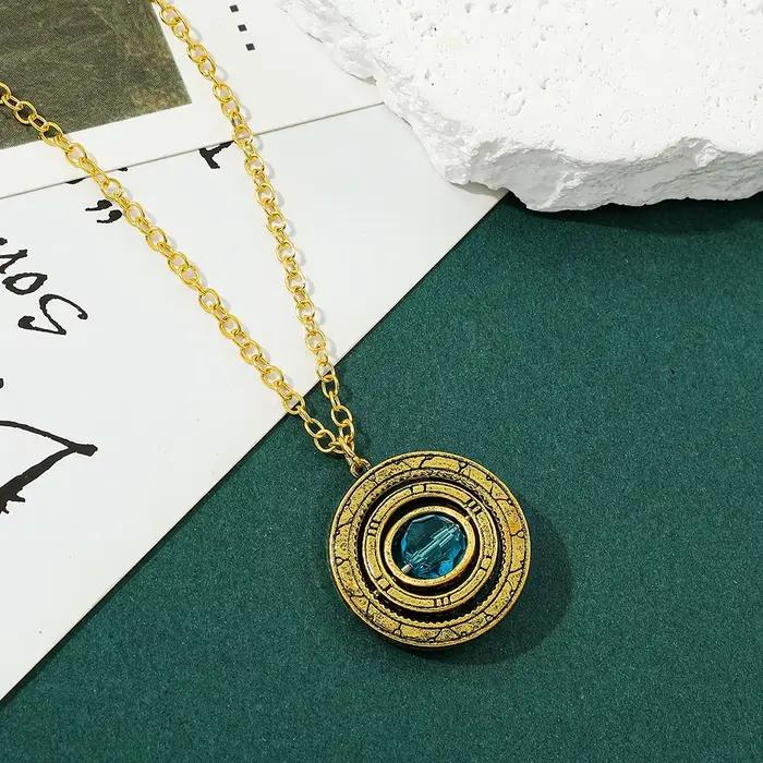 Collier Pendentif Planète Rotative Vintage en Or Antique avec Cristal Bleu, Bijou Saturne Rétro Tournant