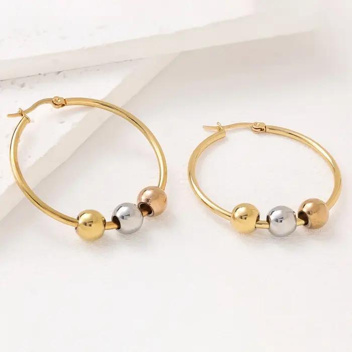 Boucles d'oreilles créoles Huggie à trois billes bicolores Or et Argent en Acier Inoxydable 316L